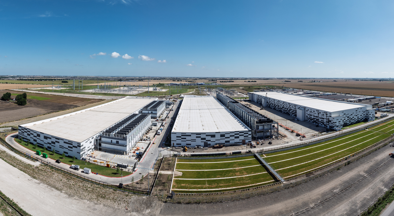 An aerial view of a data center campus beneath a blue sky